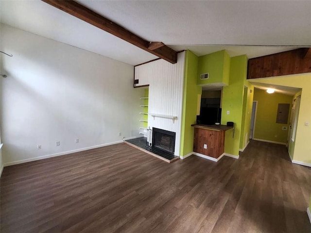 unfurnished living room featuring a large fireplace, dark wood-type flooring, electric panel, and vaulted ceiling with beams