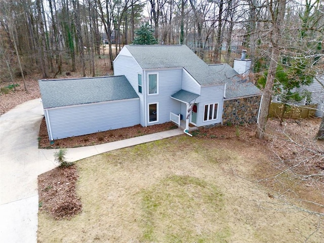5419 S Lake Dr, Douglasville, GA 30135 - view of front facade featuring a chimney, roof with shingles, concrete driveway, and view of scattered trees
