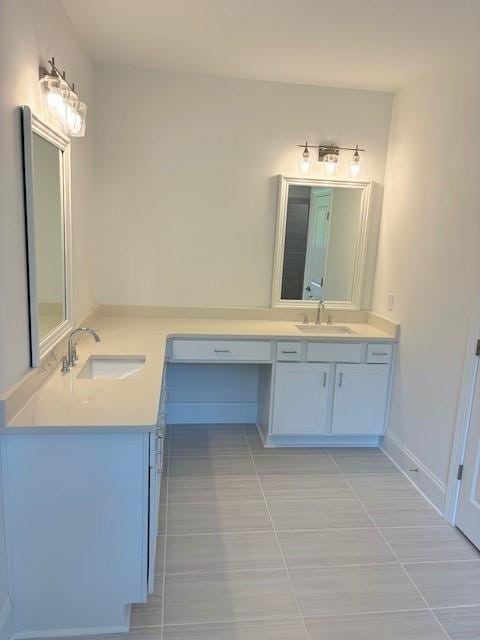 bathroom featuring tile patterned flooring and vanity