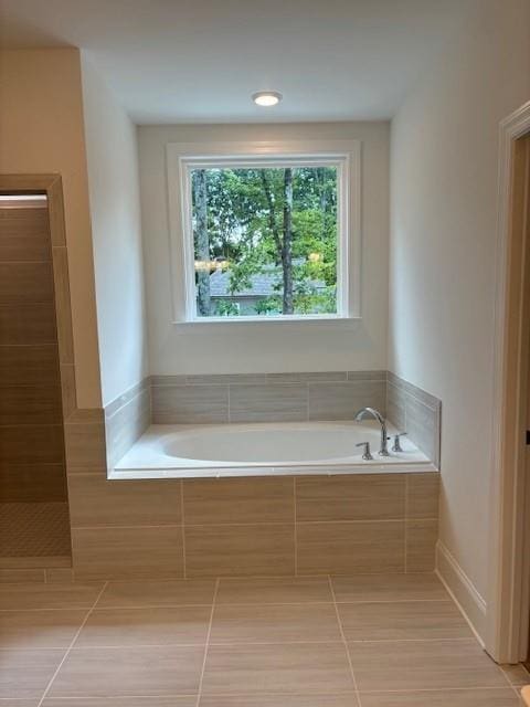 bathroom featuring tile patterned flooring and separate shower and tub