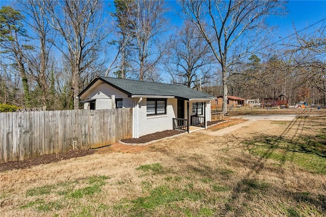 view of outbuilding featuring fence