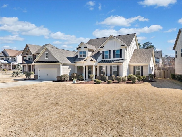 view of front facade with driveway, fence, a residential view, board and batten siding, and a garage