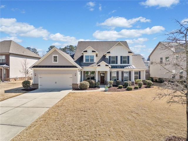 view of front of property featuring a standing seam roof, concrete driveway, an attached garage, and metal roof