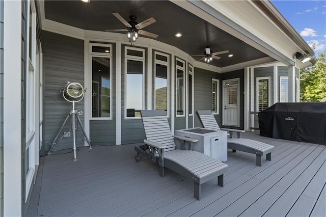 wooden deck with area for grilling and ceiling fan