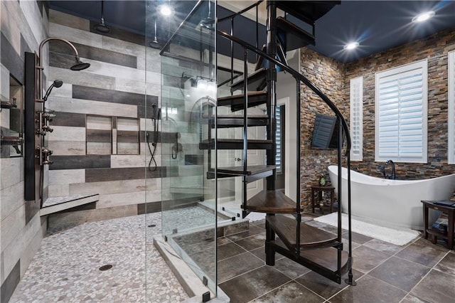 bathroom featuring tile walls and independent shower and bath