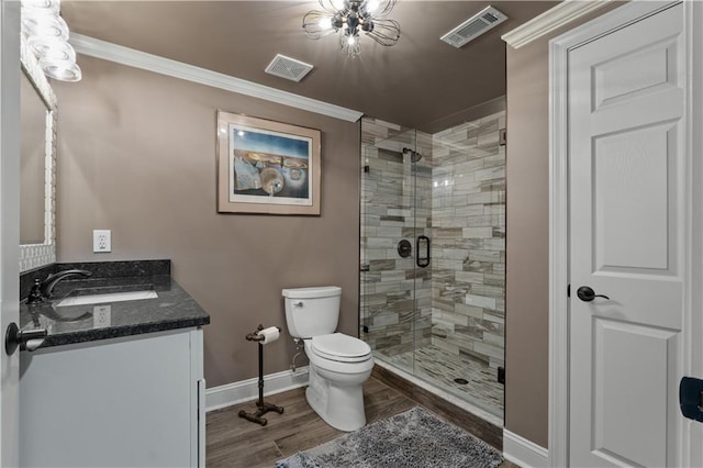 bathroom featuring toilet, hardwood / wood-style floors, a shower with door, crown molding, and vanity