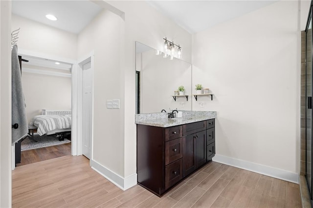 415 Stoneledge Rd, Jasper, GA 30143 - bathroom featuring wood finished floors, vanity, recessed lighting, and ensuite bathroom