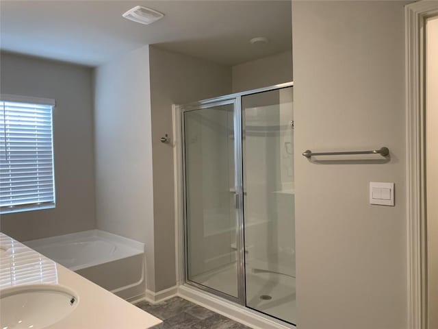 bathroom with vanity and separate shower and tub