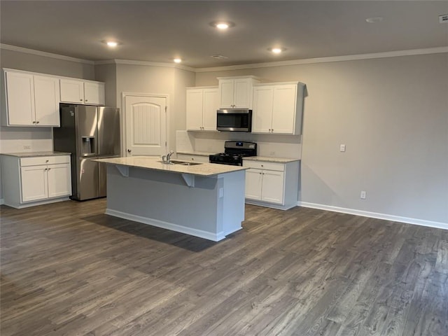 kitchen with a kitchen island with sink, sink, white cabinetry, and appliances with stainless steel finishes