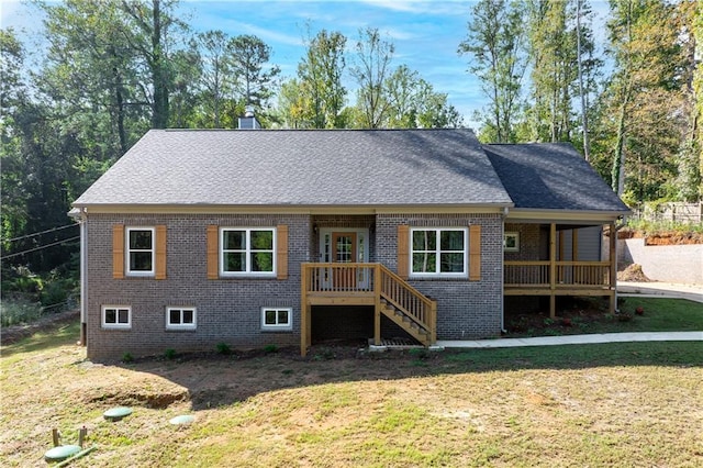 rear view of property with a yard