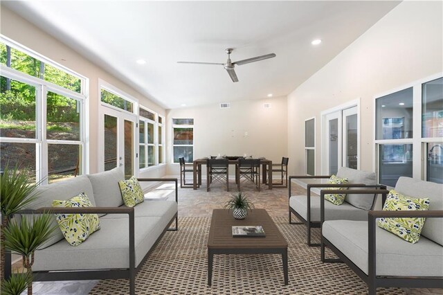 sunroom / solarium with ceiling fan and french doors