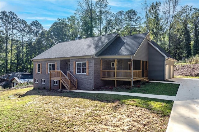 ranch-style home featuring a garage, covered porch, and a front lawn