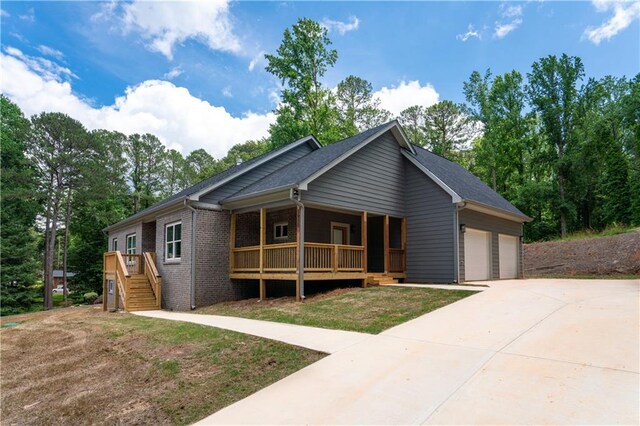 view of front facade featuring a porch and a garage