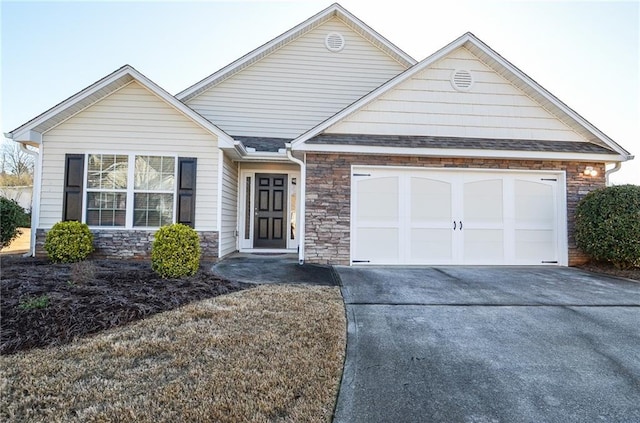 single story home featuring stone siding, driveway, a shingled roof, and a garage