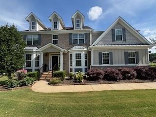 337 Long Shore Way, Newnan, GA 30265 - view of front facade featuring a front lawn and board and batten siding