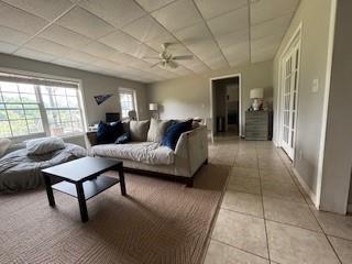 337 Long Shore Way, Newnan, GA 30265 - living room with a drop ceiling, light tile patterned flooring, and a ceiling fan