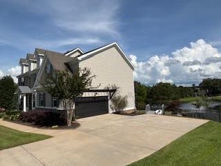 337 Long Shore Way, Newnan, GA 30265 - view of side of home with a garage and driveway