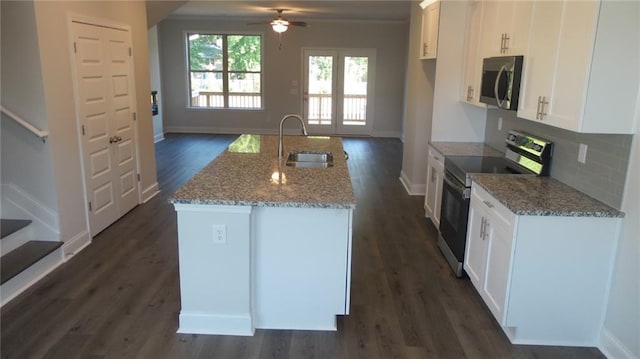 559 Fundao Ln Unit 21, Lawrenceville, GA 30046 - kitchen featuring sink, stainless steel appliances, light stone counters, white cabinets, and a center island with sink
