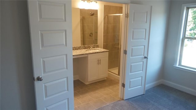 559 Fundao Ln Unit 21, Lawrenceville, GA 30046 - bathroom featuring a shower with door, vanity, a healthy amount of sunlight, and tile patterned floors