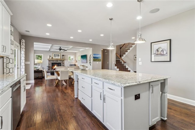 5365 Vendelay Ln, Cumming, GA 30040 - kitchen with a stone fireplace, dark wood-type flooring, recessed lighting, baseboards, and a kitchen island