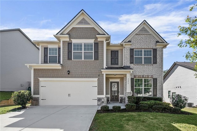 craftsman house with concrete driveway, a front lawn, central AC, and an attached garage