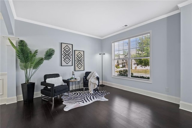 sitting room featuring ornamental molding, wood finished floors, visible vents, and baseboards