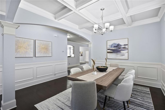 dining area featuring dark wood-type flooring, arched walkways, beamed ceiling, and ornate columns