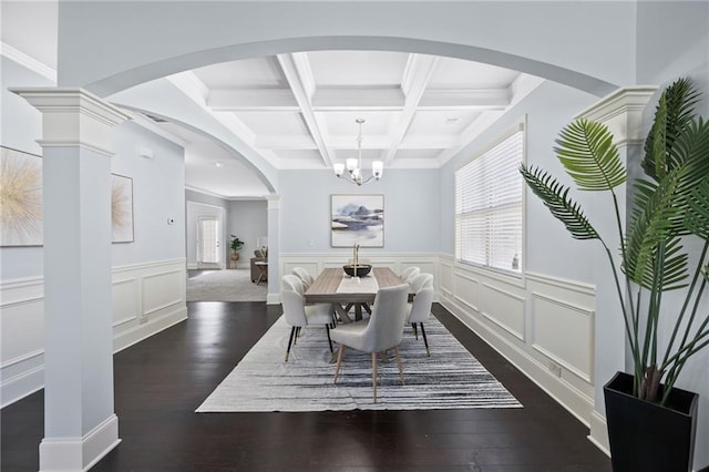 dining area featuring dark wood-style flooring, coffered ceiling, beam ceiling, and a healthy amount of sunlight