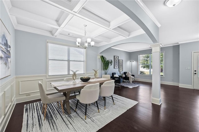 dining area featuring plenty of natural light, decorative columns, arched walkways, and wood finished floors