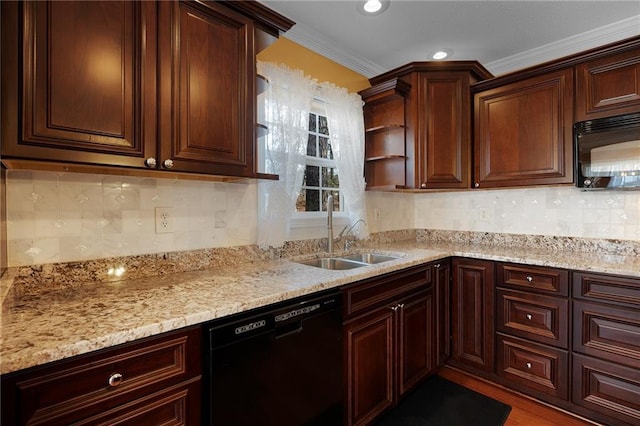 kitchen with backsplash, crown molding, light stone counters, black appliances, and a sink