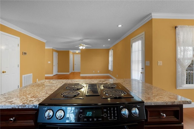 kitchen featuring black electric range, visible vents, a textured ceiling, and crown molding