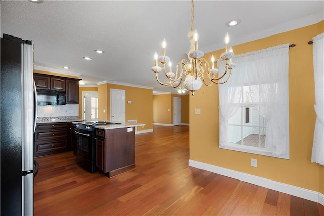 kitchen with dark brown cabinets, dark wood-type flooring, black appliances, and crown molding