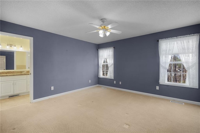 unfurnished bedroom featuring visible vents, light colored carpet, and baseboards