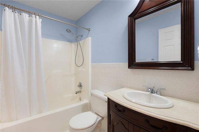 bathroom featuring toilet, vanity, and shower / tub combo