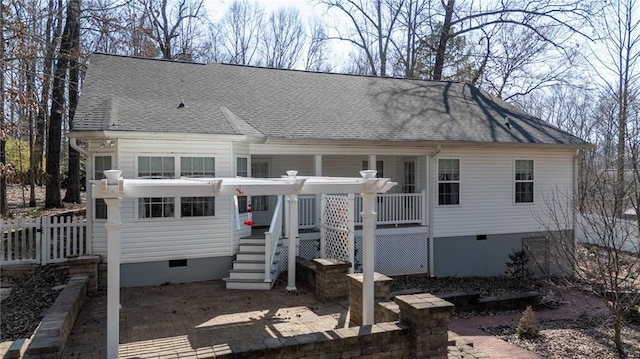 view of front facade featuring crawl space, roof with shingles, and fence