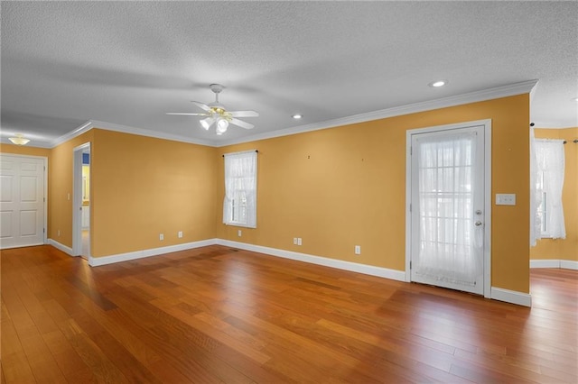 interior space featuring hardwood / wood-style floors, crown molding, and a textured ceiling