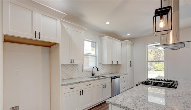 kitchen featuring light stone counters, sink, white cabinetry, and dishwasher