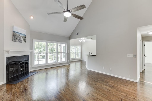 4690 Martins Crossing W Dr, Flowery Branch, GA 30542 - unfurnished living room with high vaulted ceiling, ceiling fan, a high end fireplace, baseboards, and wood finished floors