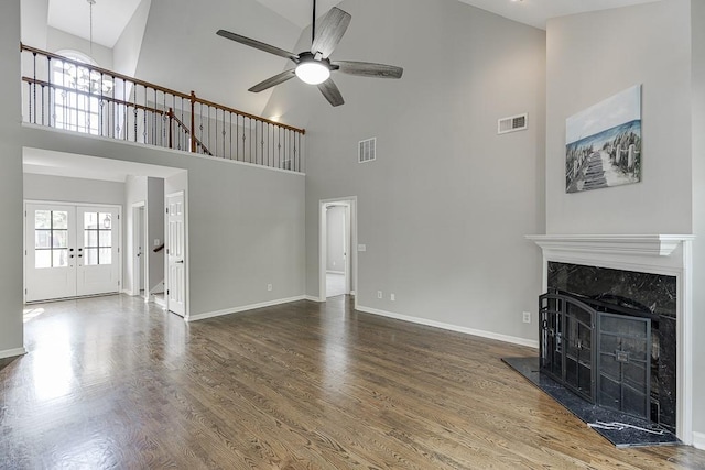 4690 Martins Crossing W Dr, Flowery Branch, GA 30542 - unfurnished living room featuring a high ceiling, a ceiling fan, baseboards, a premium fireplace, and wood finished floors