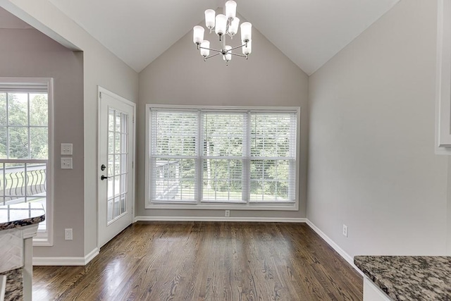 4690 Martins Crossing W Dr, Flowery Branch, GA 30542 - unfurnished dining area with plenty of natural light, a chandelier, dark wood finished floors, vaulted ceiling, and baseboards