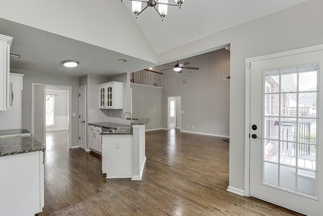 4690 Martins Crossing W Dr, Flowery Branch, GA 30542 - kitchen with a sink, plenty of natural light, white cabinetry, glass insert cabinets, and high vaulted ceiling
