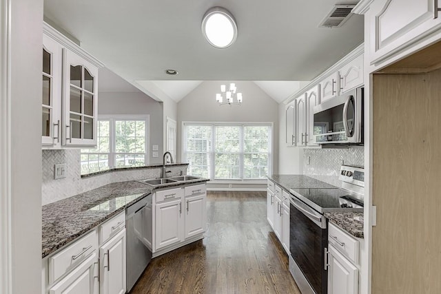 4690 Martins Crossing W Dr, Flowery Branch, GA 30542 - kitchen featuring stainless steel appliances, a sink, glass insert cabinets, dark wood-style floors, and white cabinets