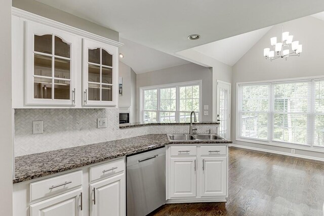 4690 Martins Crossing W Dr, Flowery Branch, GA 30542 - kitchen with dishwasher, a sink, lofted ceiling, glass insert cabinets, and decorative backsplash