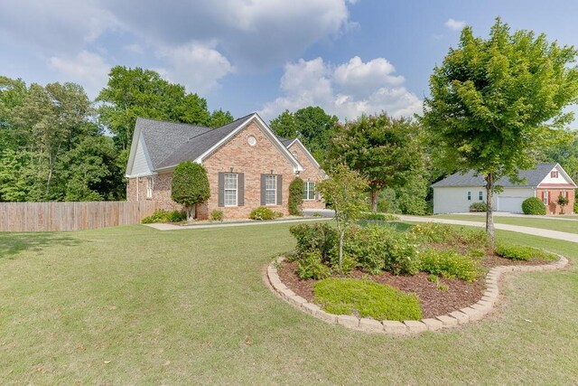 4690 Martins Crossing W Dr, Flowery Branch, GA 30542 - view of front of home featuring driveway, a front lawn, an attached garage, and brick siding