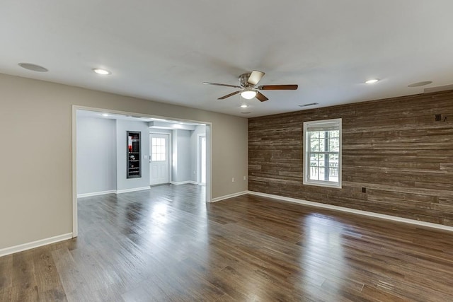 4690 Martins Crossing W Dr, Flowery Branch, GA 30542 - empty room featuring a ceiling fan, wooden walls, baseboards, wood finished floors, and recessed lighting