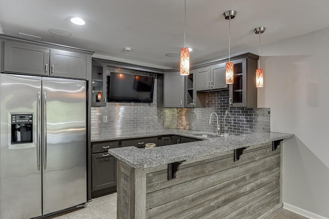 4690 Martins Crossing W Dr, Flowery Branch, GA 30542 - kitchen with stainless steel refrigerator with ice dispenser, a sink, a peninsula, a kitchen bar, and glass insert cabinets