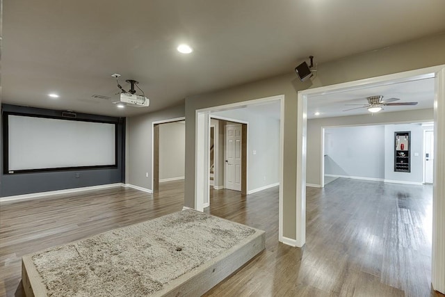4690 Martins Crossing W Dr, Flowery Branch, GA 30542 - home theater room with wood finished floors, ceiling fan, baseboards, and recessed lighting