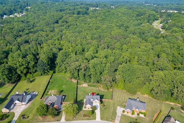 4690 Martins Crossing W Dr, Flowery Branch, GA 30542 - aerial overview of property's location with a heavily wooded area