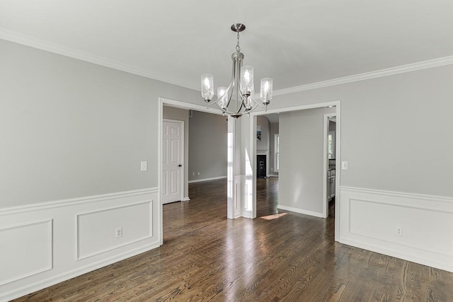 4690 Martins Crossing W Dr, Flowery Branch, GA 30542 - unfurnished dining area featuring a chandelier, crown molding, wainscoting, dark wood-style floors, and arched walkways