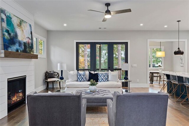 660 Timm Valley Rd NE, Atlanta, GA 30305 - living area featuring baseboards, wood finished floors, recessed lighting, a ceiling fan, and a glass covered fireplace